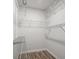 Walk-in closet with plenty of storage with wire rack shelving and Luxury Vinyl Plank flooring at 8624 Grassy Oak Trl, North Charleston, SC 29420