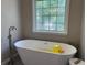 Bright bathroom featuring a stylish freestanding tub and a large window at 8701 Caspiana Ln, North Charleston, SC 29420