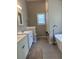 Bright bathroom featuring a stylish freestanding tub, walk in shower, and dual sinks at 8701 Caspiana Ln, North Charleston, SC 29420