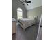 Comfortable bedroom with a queen-size bed, neutral tones, and arched windows for natural light at 8701 Caspiana Ln, North Charleston, SC 29420