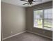 Neutral bedroom with plush carpet, a ceiling fan, and natural light from the window at 8701 Caspiana Ln, North Charleston, SC 29420