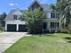 Charming two-story home boasting a brick facade, two-car garage, and a well-maintained front yard at 8701 Caspiana Ln, North Charleston, SC 29420