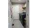 Well-organized laundry room featuring modern washer and dryer units, tiled floor, and efficient shelving at 8701 Caspiana Ln, North Charleston, SC 29420