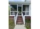 Inviting screened porch with comfortable seating and steps leading down to the backyard at 8701 Caspiana Ln, North Charleston, SC 29420
