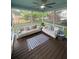 Relaxing screened porch featuring two sofas and a ceiling fan at 8701 Caspiana Ln, North Charleston, SC 29420