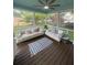 Relaxing screened porch featuring two sofas and a ceiling fan at 8701 Caspiana Ln, North Charleston, SC 29420
