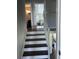 Traditional stairway with stained wood treads and painted risers, leading to the home's upper level and bedroom at 8701 Caspiana Ln, North Charleston, SC 29420