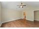Large bedroom with wood-look floors and ceiling fan, conveniently located near the ensuite bathroom at 8800 Dorchester Rd # 4001, North Charleston, SC 29420