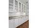 Extensive kitchen cabinetry with glass fronts, under-cabinet lighting, and granite countertops at 8800 Dorchester Rd # 4001, North Charleston, SC 29420