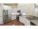 Well-lit kitchen features stainless steel appliances, sleek white cabinetry, and granite countertops at 8800 Dorchester Rd # 4001, North Charleston, SC 29420