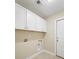 An ample laundry room with white cabinets and tile floors at 8800 Dorchester Rd # 4001, North Charleston, SC 29420