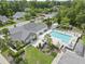 Community pool with lounge chairs, umbrellas, landscaped grounds, and nearby parking at 8800 Dorchester Rd # 4001, North Charleston, SC 29420
