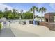 Poolside grilling area with brick oven and prep space, surrounded by palm trees at 8800 Dorchester Rd # 4001, North Charleston, SC 29420
