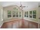Inviting sunroom with abundant natural light from numerous windows, hardwood floors, and a ceiling fan at 8800 Dorchester Rd # 4001, North Charleston, SC 29420