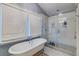 Elegant bathroom showcasing a freestanding tub and glass-enclosed shower with custom tile at 902 Mikell Dr, Charleston, SC 29412