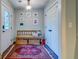 Cozy entryway featuring a wooden bench, decorative rug, and ample closet space at 902 Mikell Dr, Charleston, SC 29412