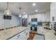 Well-lit kitchen features stainless steel appliances, white cabinetry, and granite countertops at 902 Mikell Dr, Charleston, SC 29412