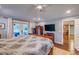 Spacious main bedroom boasts a ceiling fan, TV, and private access to an outdoor patio at 902 Mikell Dr, Charleston, SC 29412