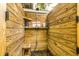 Rustic outdoor shower with wooden walls and a convenient shelf for toiletries, perfect for rinsing off after a swim at 902 Mikell Dr, Charleston, SC 29412
