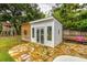 Charming pool house with french doors and a flagstone patio, offering a private retreat in the backyard at 902 Mikell Dr, Charleston, SC 29412