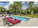 Inviting backyard swimming pool with lounge chairs and lush landscaping, perfect for relaxation and enjoyment at 902 Mikell Dr, Charleston, SC 29412