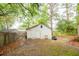 Backyard with a detached shed, mature trees, and a wooden fence providing privacy and storage space at 9887 Midview Dr, Ladson, SC 29456