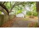 Private backyard featuring mature trees, a wooden fence, and a shed with ample storage space at 9887 Midview Dr, Ladson, SC 29456