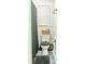 Neat bathroom featuring a toilet with a gray seat, a basket, and stylish accessories at 9887 Midview Dr, Ladson, SC 29456