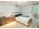 A serene bedroom featuring a bed, a dresser and plenty of natural light at 9887 Midview Dr, Ladson, SC 29456