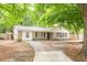 Charming brick home featuring a well-maintained lawn and a long driveway leading to the entrance at 9887 Midview Dr, Ladson, SC 29456