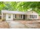 Welcoming home showcasing a manicured lawn, brick facade, and inviting front entrance at 9887 Midview Dr, Ladson, SC 29456