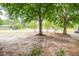 The home has a yard with mature trees and landscaping, offering shade and curb appeal at 9887 Midview Dr, Ladson, SC 29456