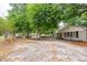 The home features a spacious front yard with mature trees, offering shade and curb appeal at 9887 Midview Dr, Ladson, SC 29456