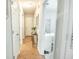 Inviting hallway with hardwood floors and views of a stylishly decorated room at 9887 Midview Dr, Ladson, SC 29456