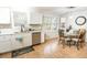 Well-lit kitchen featuring updated cabinetry, modern appliances, and an adjacent dining area at 9887 Midview Dr, Ladson, SC 29456