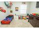 Cozy playroom showcasing 'Cars' themed decorations, a toy storage net, and organized play stations at 9887 Midview Dr, Ladson, SC 29456