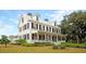 Charming multi-story home with a welcoming front porch, American flag, and manicured lawn at 1011 Old Field Dr, Summerville, SC 29483