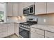 Modern kitchen features stainless steel appliances, granite countertops, tile backsplash, and ample storage in its cabinets at 1011 Old Field Dr, Summerville, SC 29483