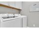Bright laundry room with white washer and dryer, ample cabinet space, and a convenient wall-mounted calendar at 1011 Old Field Dr, Summerville, SC 29483