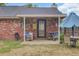 Covered patio with chairs, wood pile, and views of the backyard at 1019 Tj Ln, Summerville, SC 29486
