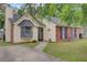 Charming single-Gathering home with brick accents, black shutters, and a well-manicured lawn at 1019 Tj Ln, Summerville, SC 29486