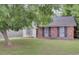 Charming home featuring a brick facade and large shade tree in the front yard at 1019 Tj Ln, Summerville, SC 29486
