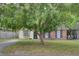 Charming home featuring a brick facade and large shade tree in the front yard at 1019 Tj Ln, Summerville, SC 29486