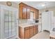 Kitchen includes tile floors, wood cabinets, and a window overlooking the backyard at 1019 Tj Ln, Summerville, SC 29486