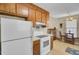 Kitchen with tile floors, wood cabinets, and white appliances at 1019 Tj Ln, Summerville, SC 29486