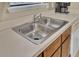 Kitchen stainless steel sink with wood cabinets and Corian countertops at 1019 Tj Ln, Summerville, SC 29486