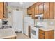 Kitchen with tile floor, wood cabinets, and white appliances at 1019 Tj Ln, Summerville, SC 29486