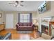 Cozy living room with a fireplace, hardwood floors, and natural light at 1019 Tj Ln, Summerville, SC 29486