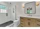 Beautifully renovated bathroom with glass shower, modern vanity, stylish mirror, and patterned tile flooring at 1023 Shelley Rd, Charleston, SC 29407