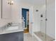 Bright bathroom featuring double vanity, shower with glass door, and mosaic tile flooring at 1023 Shelley Rd, Charleston, SC 29407